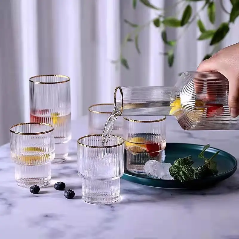 https://ae01.alicdn.com/kf/Sa29a51a59e40480184a02270997406dbl/Nordic-Vertical-Pattern-Glass-Water-Cup-with-Golden-Rim-Bottle-Cold-Cool-Household-Set.jpg