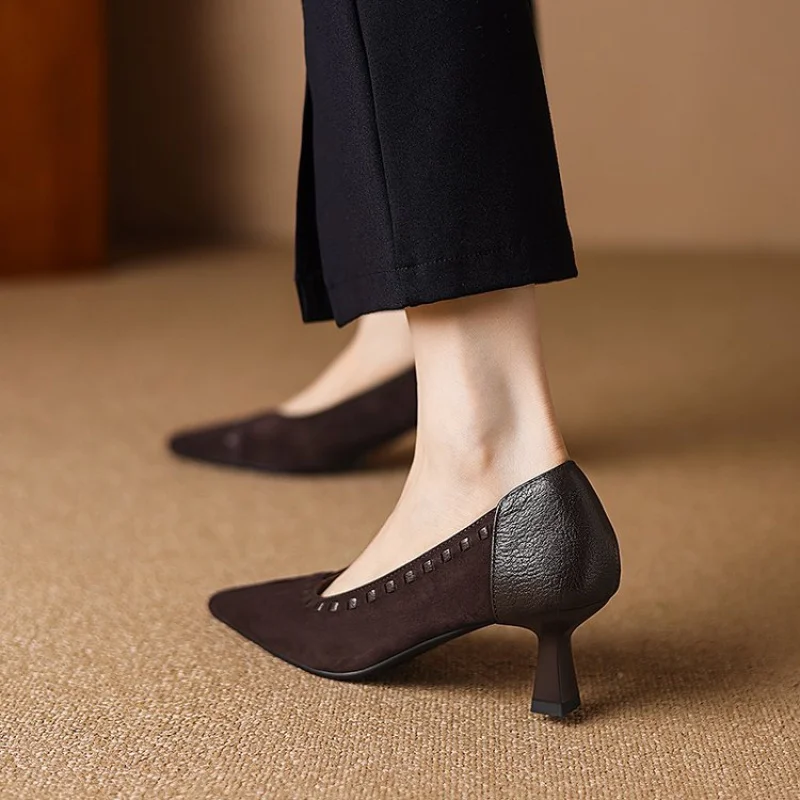 Dark Brown Pointed Toe Kitten Heel Pump Side View Dark brown pointed toe kitten heel pump with slim low heel worn with black trousers on beige carpet