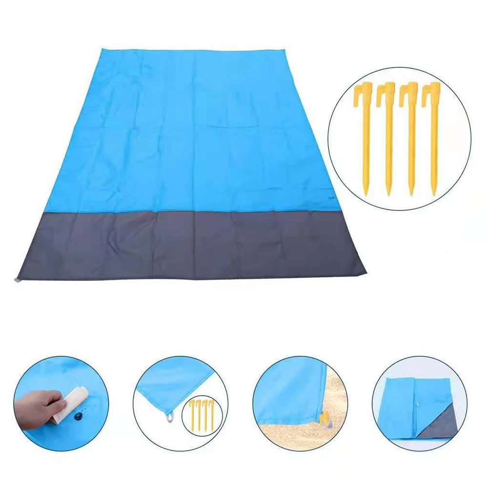 Picnic setup on a large outdoor blanket