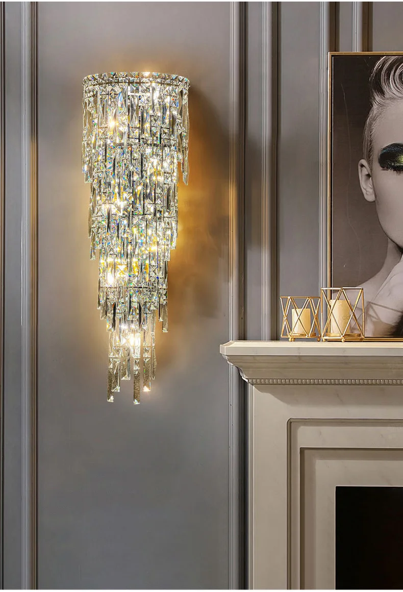 An upscale living room with a fireplace and a luxury crystal wall sconce.