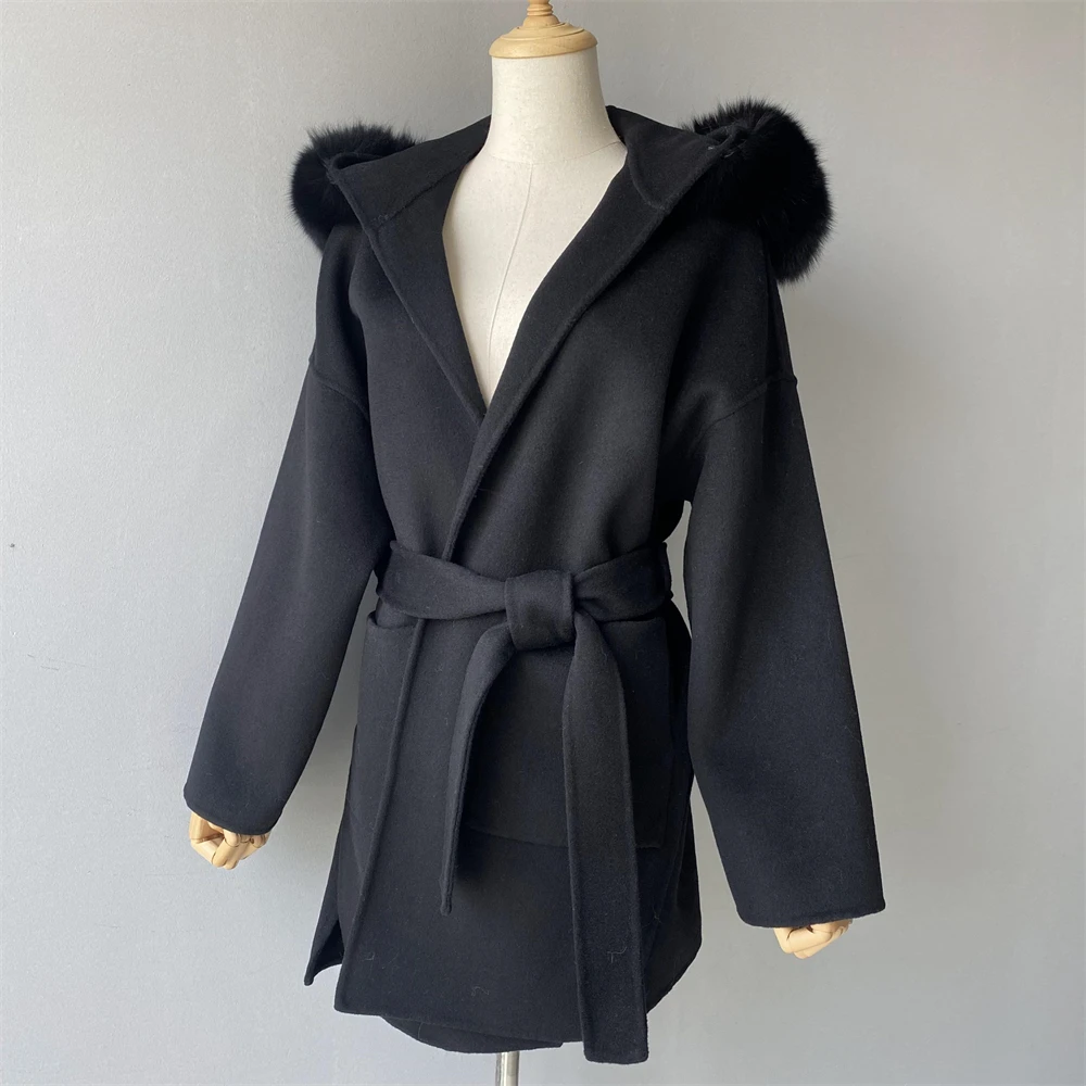 Close-up of covered button closure on cashmere coat