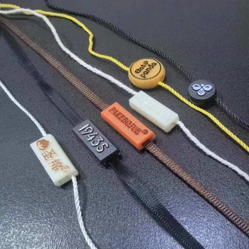 3D Embossed Brand Name Garment Hang Tag Rope Loops Plastic Seal Label Sustainable Hang Tag Rope Lock