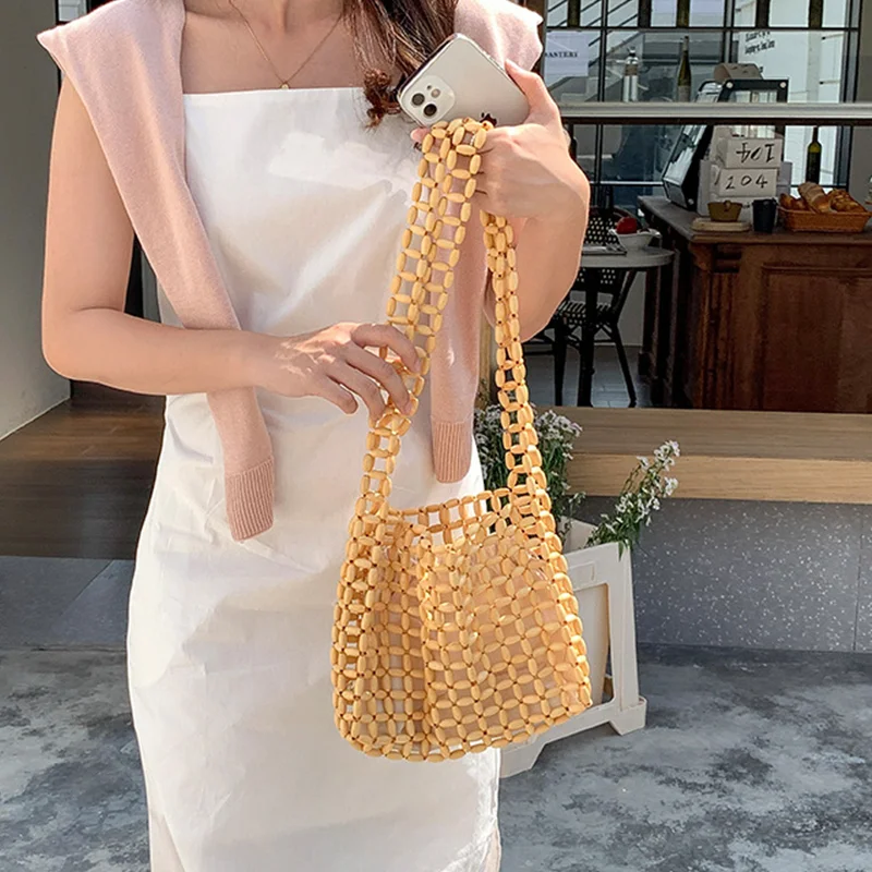 

Модная ажурная сумка через плечо с деревянными бусинами, женские дизайнерские плетеные сумки из бисера, женская летняя повседневная пляжная сумка, Женский кошелек с Бали