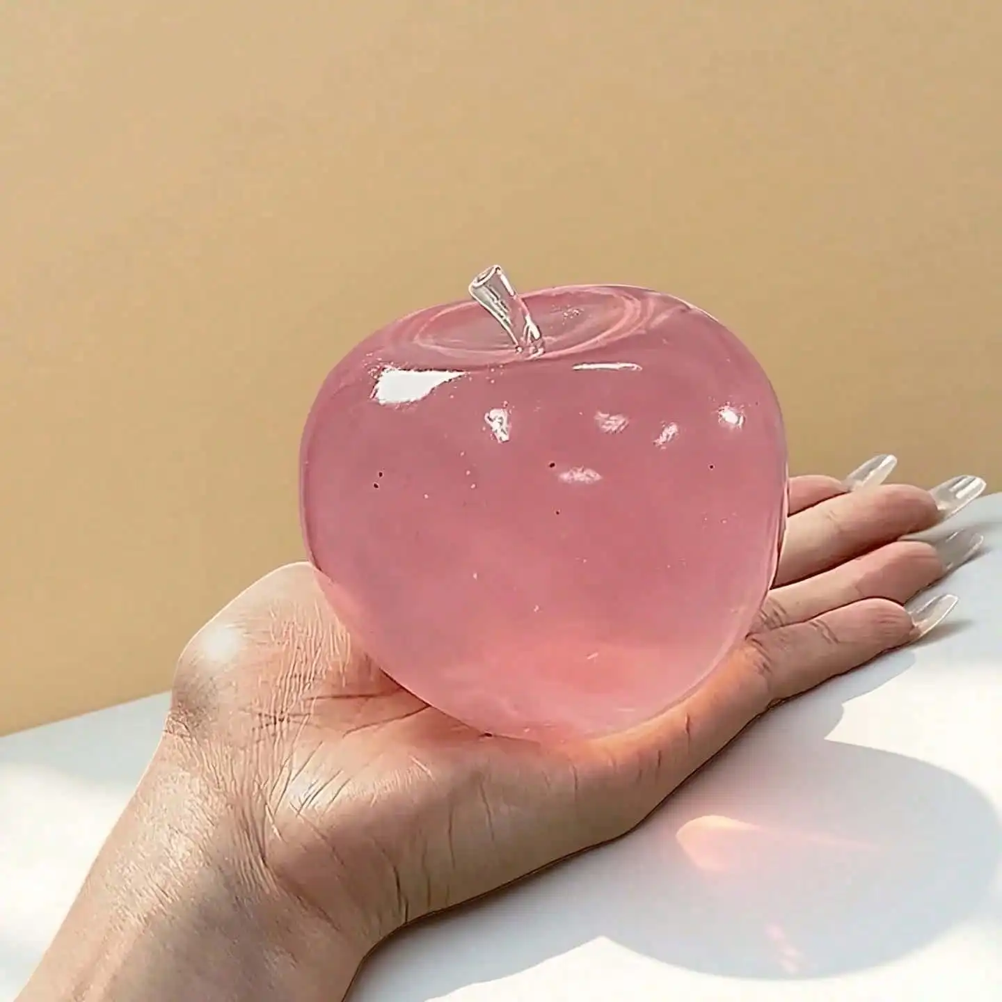 Sa6dfc4f2c1904fd7af713f1c5ad0547am.jpg A Soft Pastel-Colored Crystal Apple With An Ultra-Thin Skin And A Smooth, Pliable Texture. It Is A Squeezable Stress Ball Toy As Well As A Tactile Sensory Toy. Ideal For Desktop Display And A Great Stress-Relieving Gift For The Office - Image 1