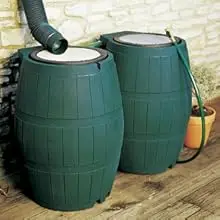 RC4000 Green rain barrels linked together in front of a brick wall