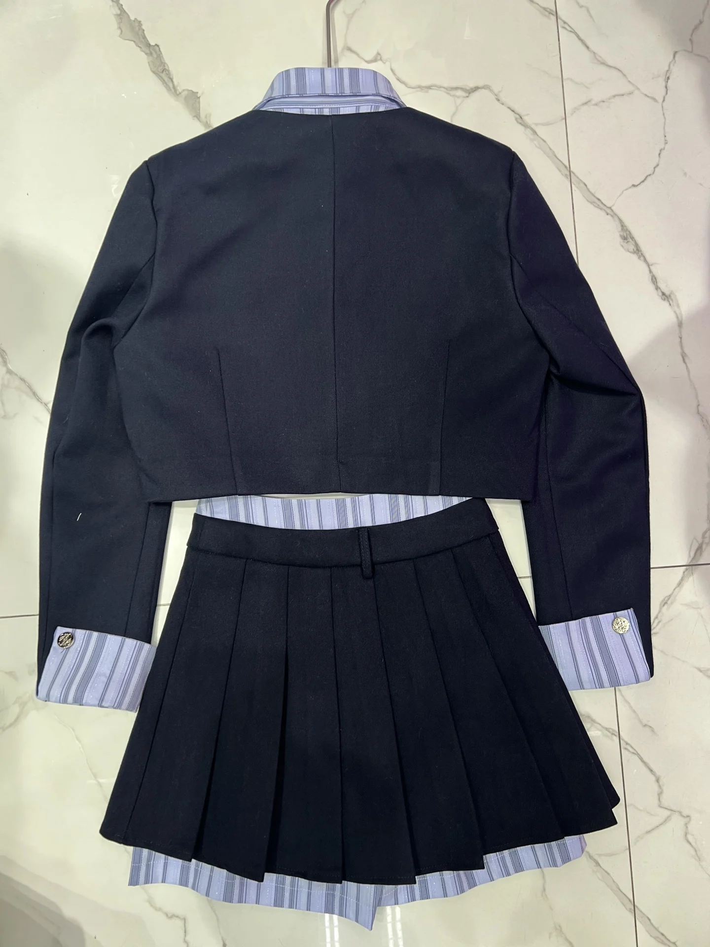 

Coat top with striped contrasting color design, flap decorated cuffs, high waisted A-line skirt, small suit half skirt set