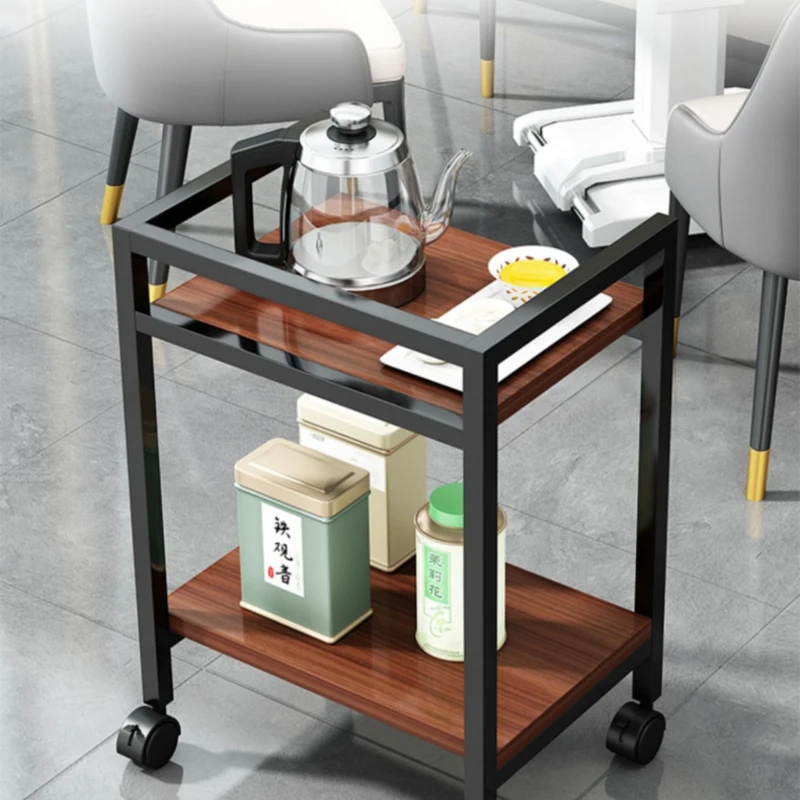 

A movable small table under the desk of a floor standing office printer storage rack