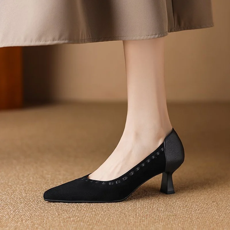 Black Pointed Toe Kitten Heel Pumps Side View Black pointed toe kitten heel pump worn with beige skirt on beige carpet