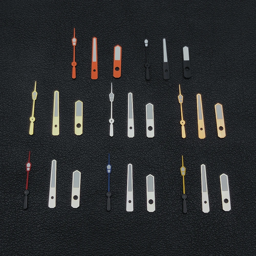Elegant Silver, Gold, and Rose Gold Watch Hands with Green Luminescence