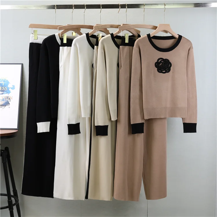 Detailed view of the floral knit pattern and high-waisted wide leg pant silhouette.