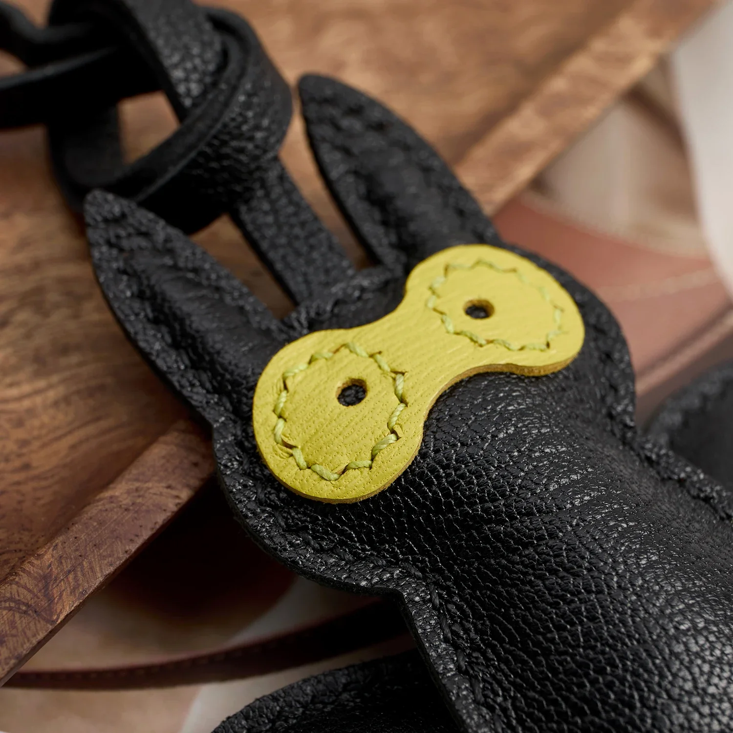 Bat leather charm hanging on handbag