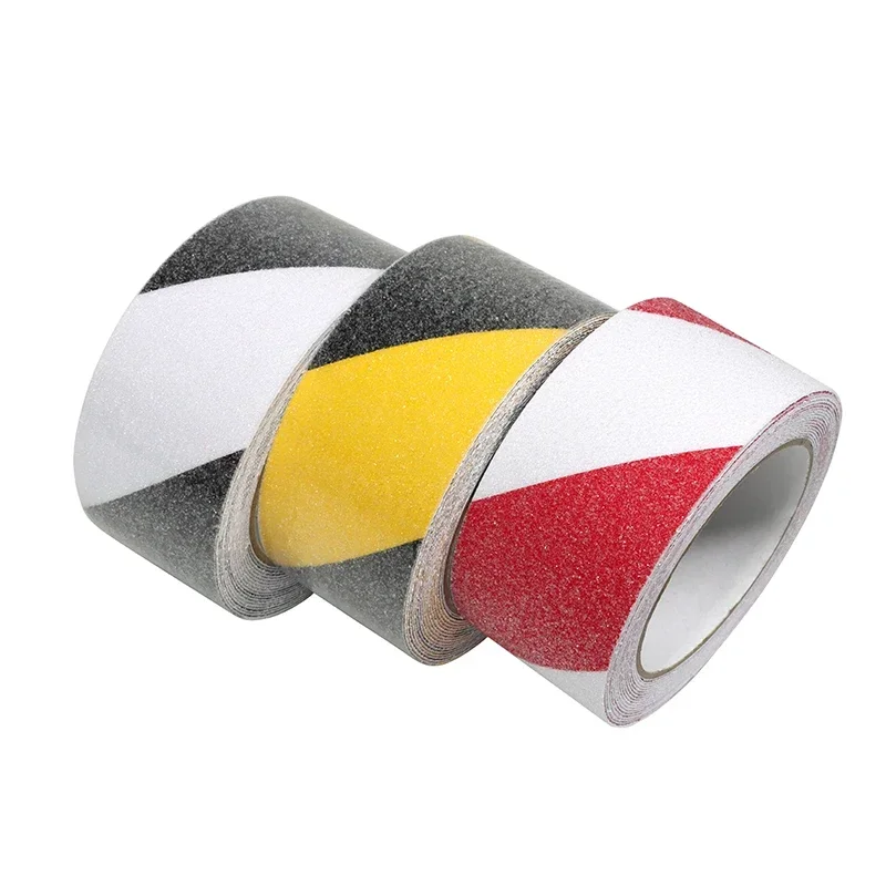 Three rolls of anti-slip safety tape in black/white, yellow/black, and red/white striped patterns.