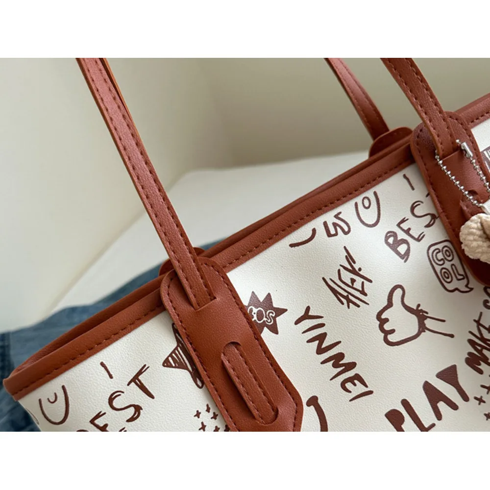 Tote women's capacity single shoulder high-end feeling large bag, 2024 new trendy and niche graffiti class commuting bag_voghion.com