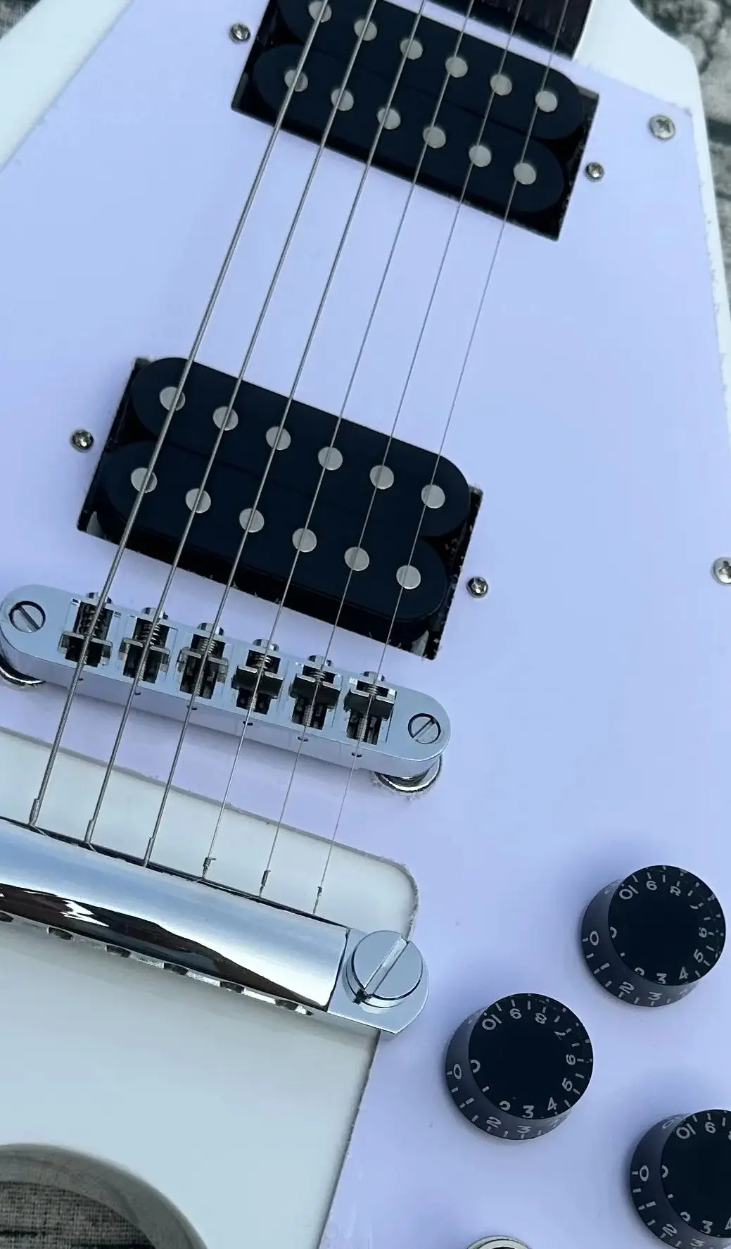 

Irregular electric guitar, white flying V, black open pickup, imported wood and paint, shiny, in stock, fast shipping