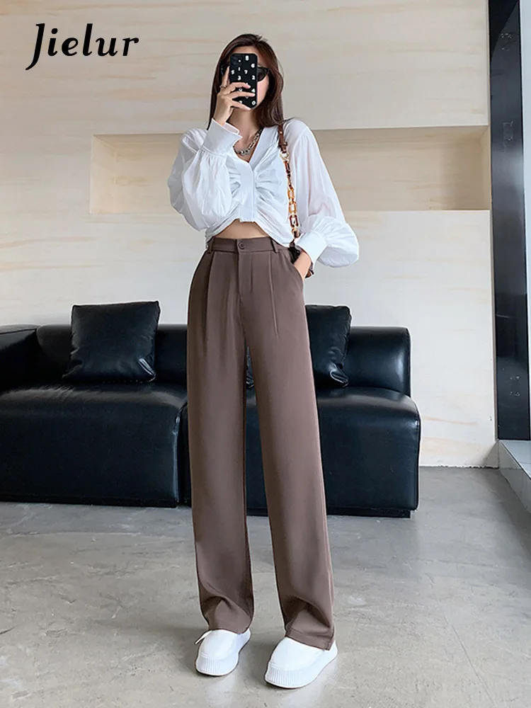 High waisted pants fashion trend. High waisted trousers. Woman attractive  brunette wear fashionable clothes. Femininity and emphasize feminine  figure. Girl wear loose high waisted pants. Fashion shop Stock Photo |  Adobe Stock