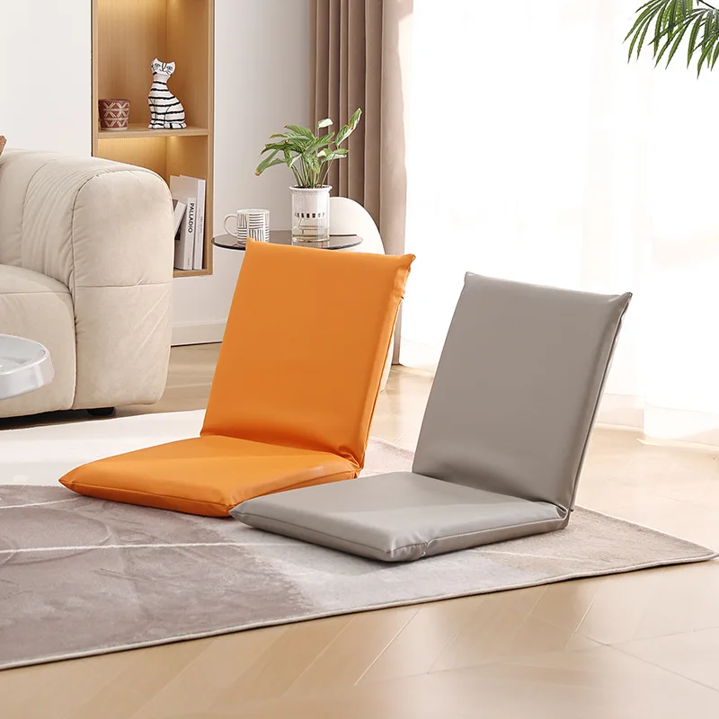 A legless chair is placed on the bed. It's a recliner without legs, a lazy person's chair.