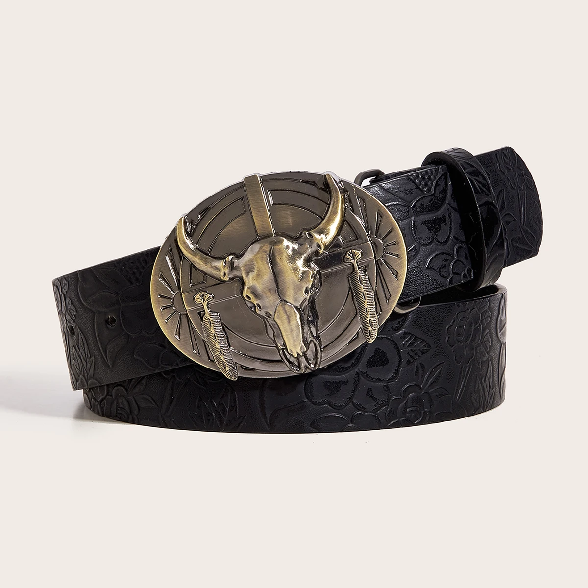 A leather belt with a buckle shaped like a cow's head in a western style, modern and casual.