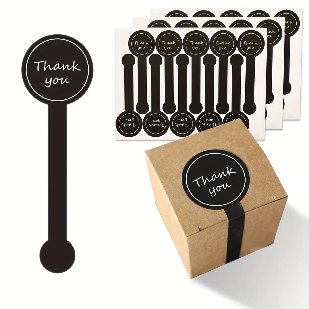 Black thank you sealing stickers displayed on a roll
