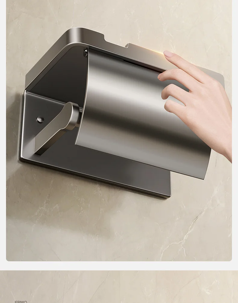 A hand reaches to open a stylish aluminum tissue holder, tastefully mounted on a light-colored marble wall in the bathroom. This modern design offers both style and functionality, making it an elegant addition to your space.