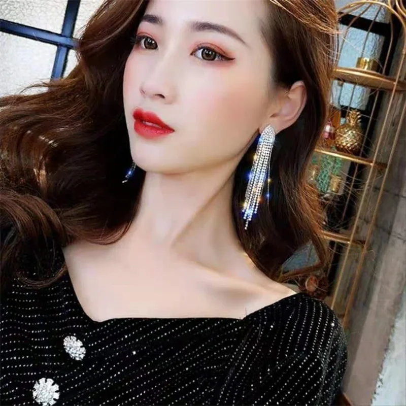 The Girl Wearing Tassel Earrings Elegant Smiling Girl Wearing Blue