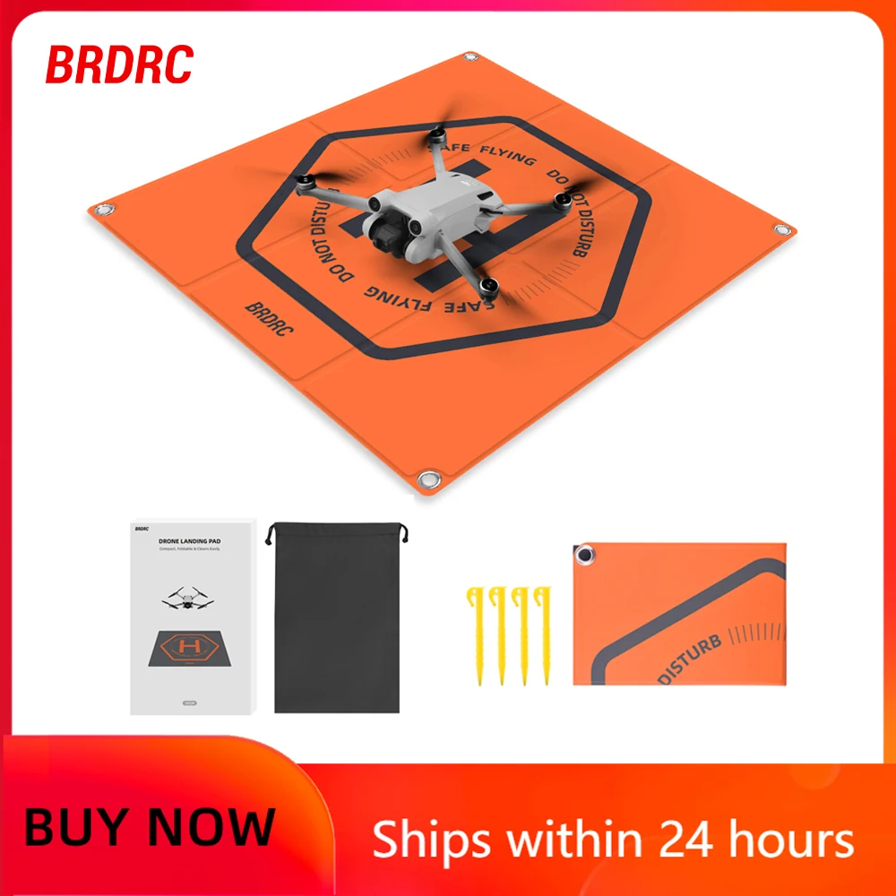 Tapis d'atterrissage double face pour drone DJI déplié au sol, motifs orange et noir pour une visibilité optimale.
