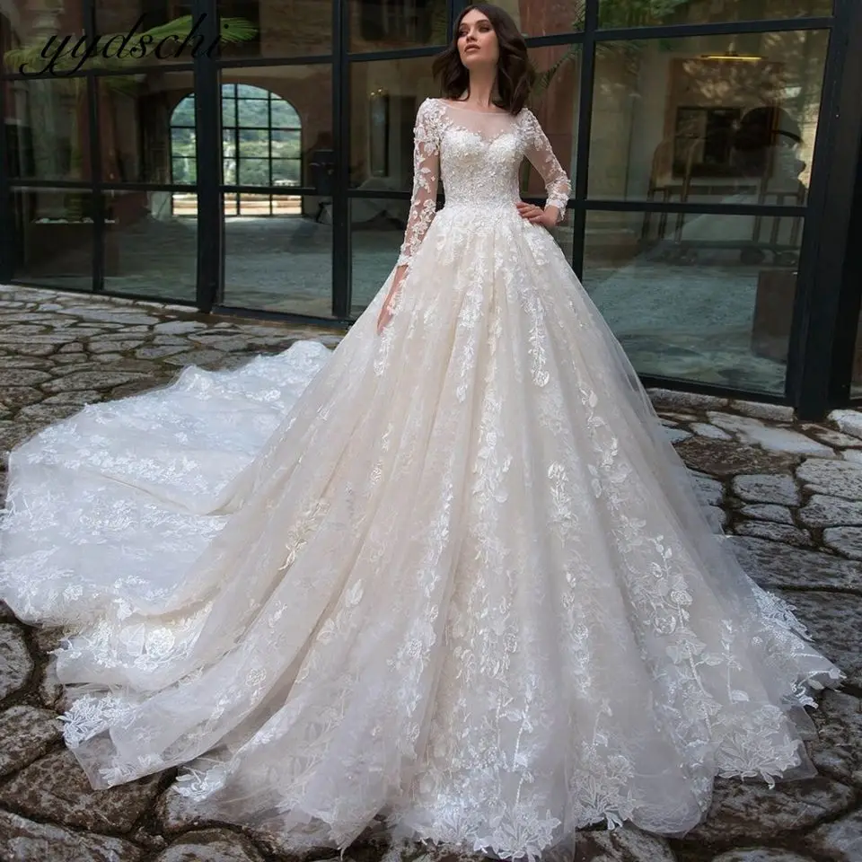 

Luxurious Long Sleeves Lace Appliques Wedding Dresses 2023 Princess Illusion Beaded With Chapel Train Vintage A-Line Bridal Gown