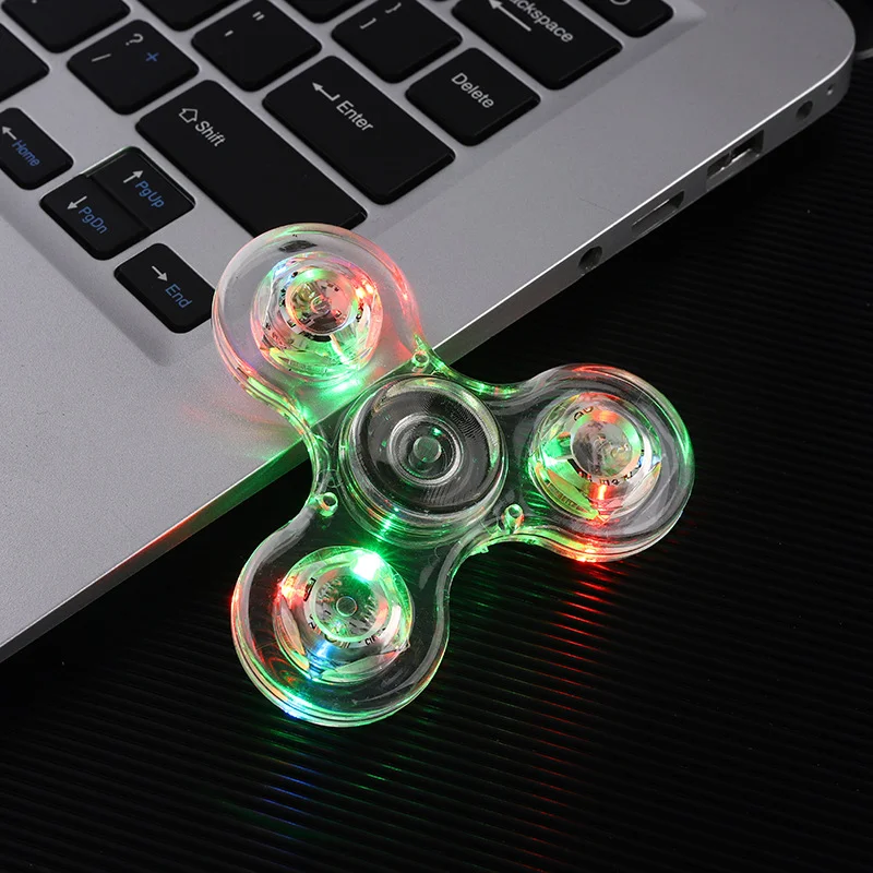 Cristal transparente LED Light-Up Finger Spinner, Brinquedos Material PVC