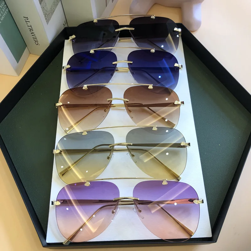 

Luxury Designer Fashion Oval Rimless SunglassesSummer Glasses Fashion Sun glasses For Men Women UV400 Sunglasses