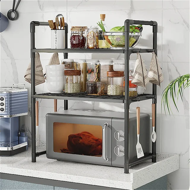 A black, 2-tier kitchen countertop shelf organizing a microwave on the bottom and spice jars on the top.