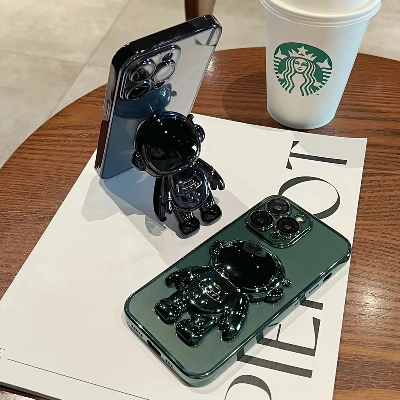 Moda Fold Standing Custodia per telefono trasparente per IPhone 11 12 13 14 15 Pro Mini XS Max XR X Placcatura Astronauta Protegge la copertura_voghion.com