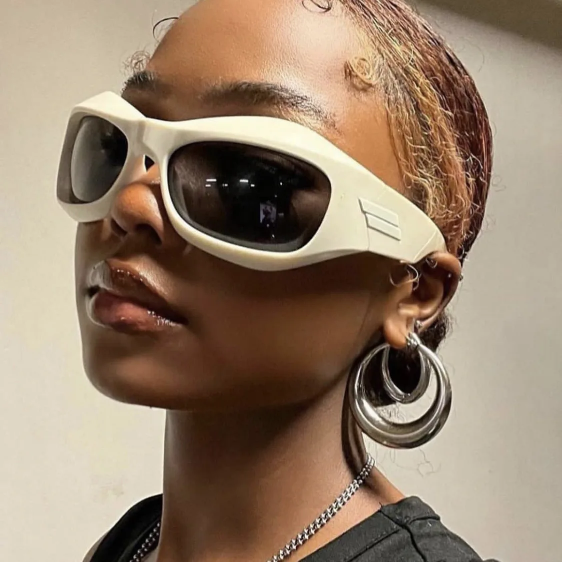 A Hip Hop Sunglasses For Women woman rocking white sunglasses.