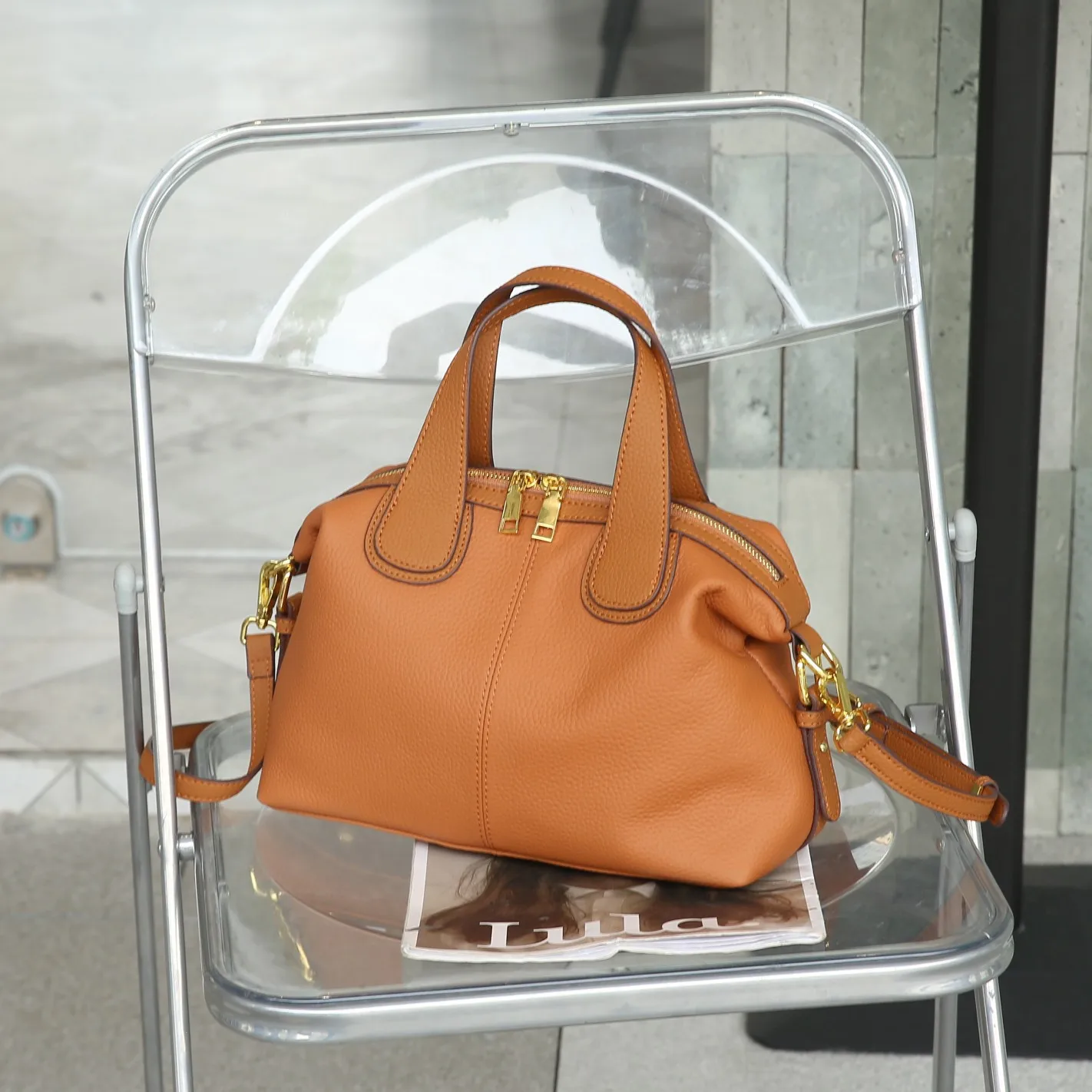 Elegant genuine leather crossbody handbag with shoulder strap and quality details