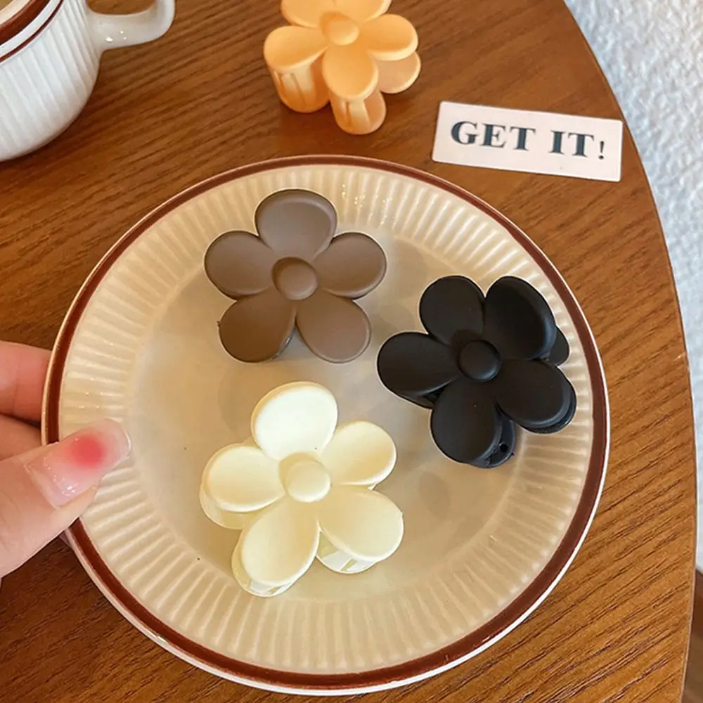 Description Picture 6 of itemCute Temperament Matte Plastic Solid Color Flower Hair Claw Women Hair Accessories Korean Style Hair Clip Ponytail Holder