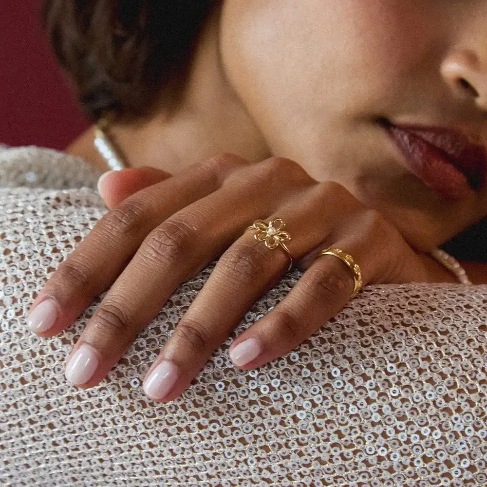 Close-up of pearl ring on hand highlighting craftsmanship