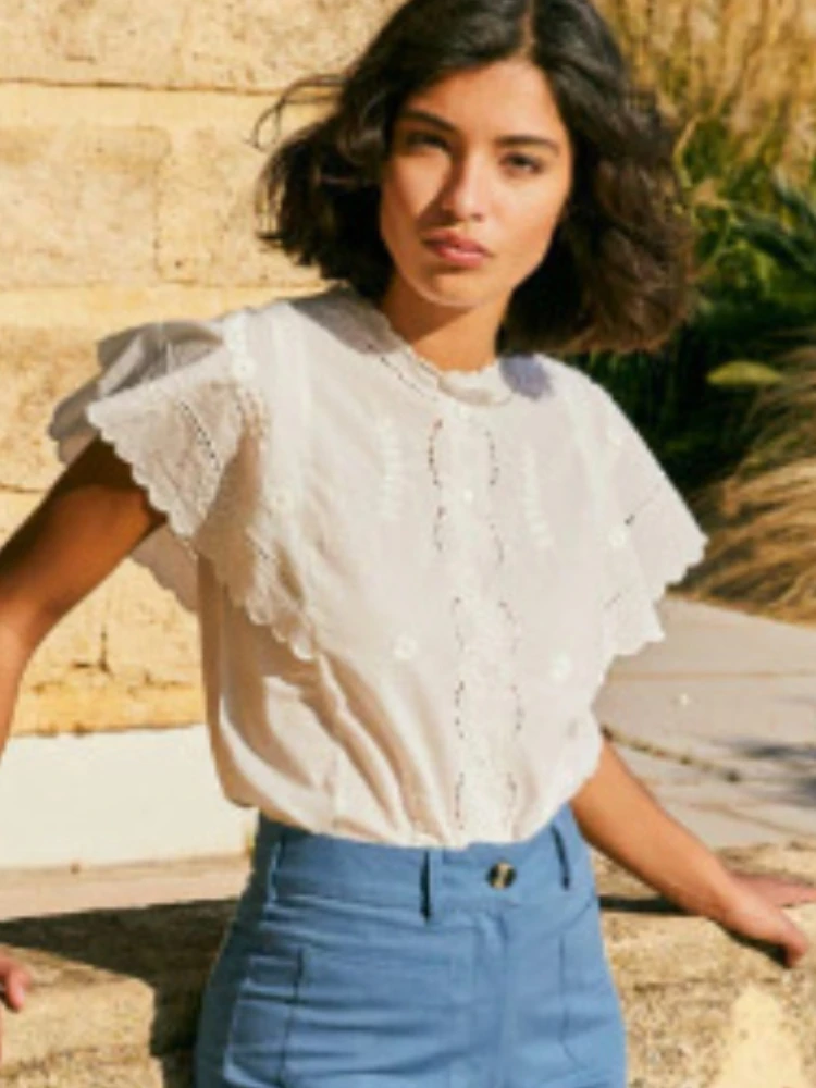 

Super chic French temperament pattern hollow ruffle shirt Women's round neck single breasted shirt short sleeved white shirt