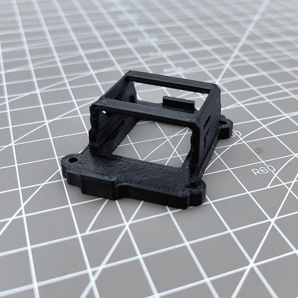Pièce de drone : support d'émetteur FPV en TPU imprimé 3D, installé sur un châssis de drone.