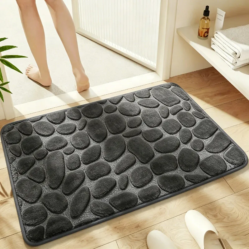 Pebble-texture absorbent bath mat in a bathroom setting