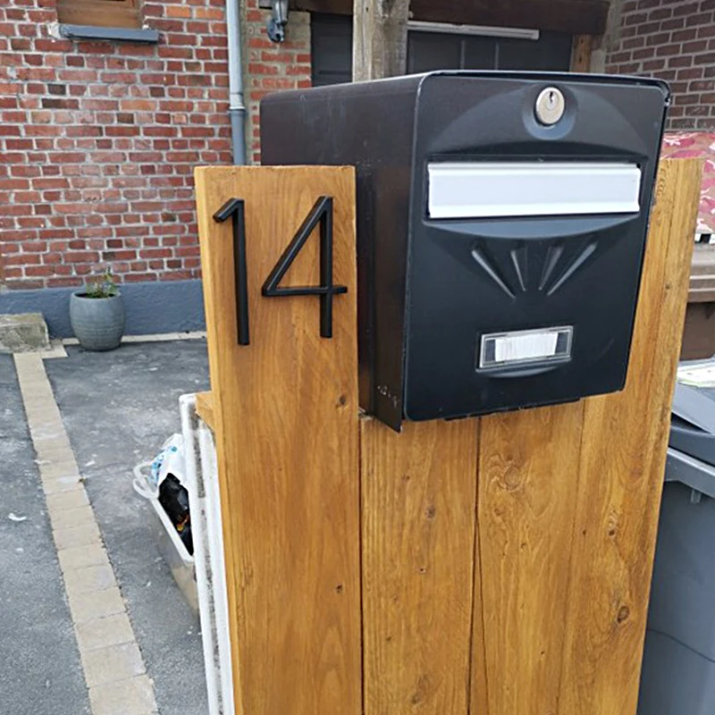 Full view of mounted address sign with multiple numbers