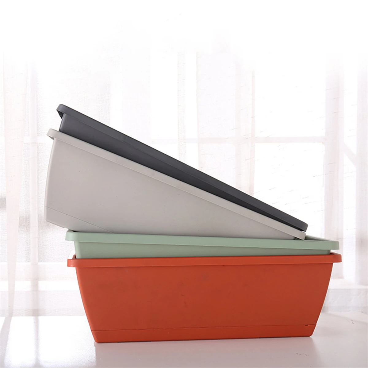 Close-up of the planter's drainage holes and removable tray.