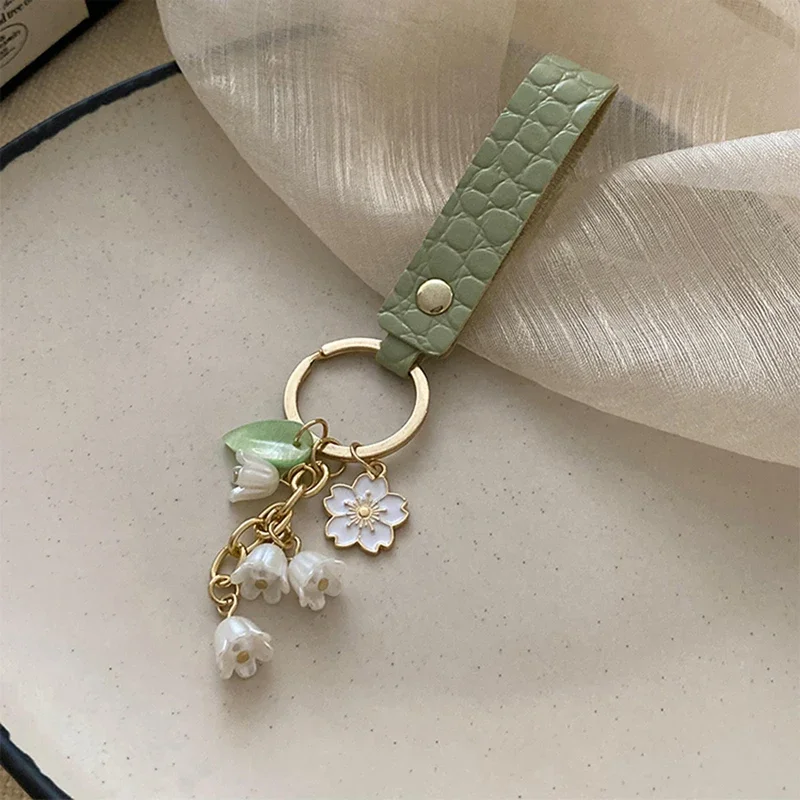 Fresh and Elegant Bell Orchid Keychain: Green Imitation Pearl and Leather Resin Alloy Accessory