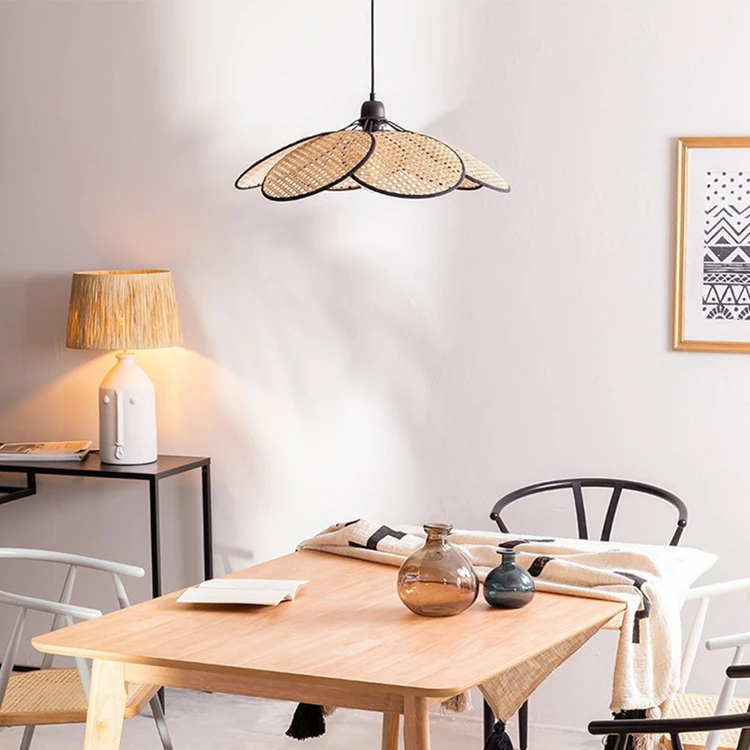 An organic meets modern dining room with a wooden table and chairs complemented by a wicker chandelier.