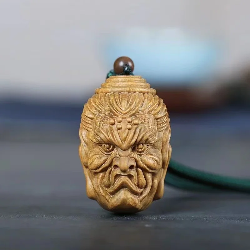 

Green sandalwood carving crafts hand carved between the Buddha and the devil between the hand of a Buddha head pendant