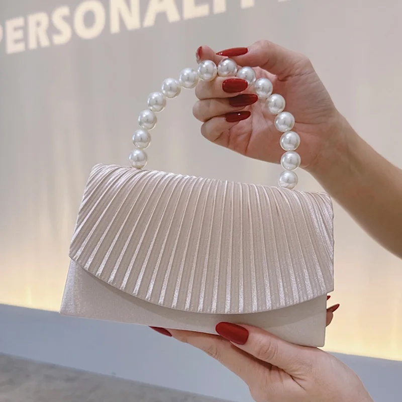 Elegant satin tote bag with pearl handle and ruffled edge design suitable for formal dinners and birthday parties