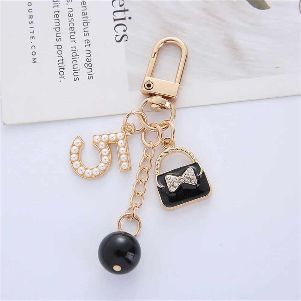 Greabuy Portachiavi da donna, alla moda con perle e fiocco, catena per telefono, grazioso ciondolo a forma di cuore, decorazione per borsa, zaino, borsa, K3159