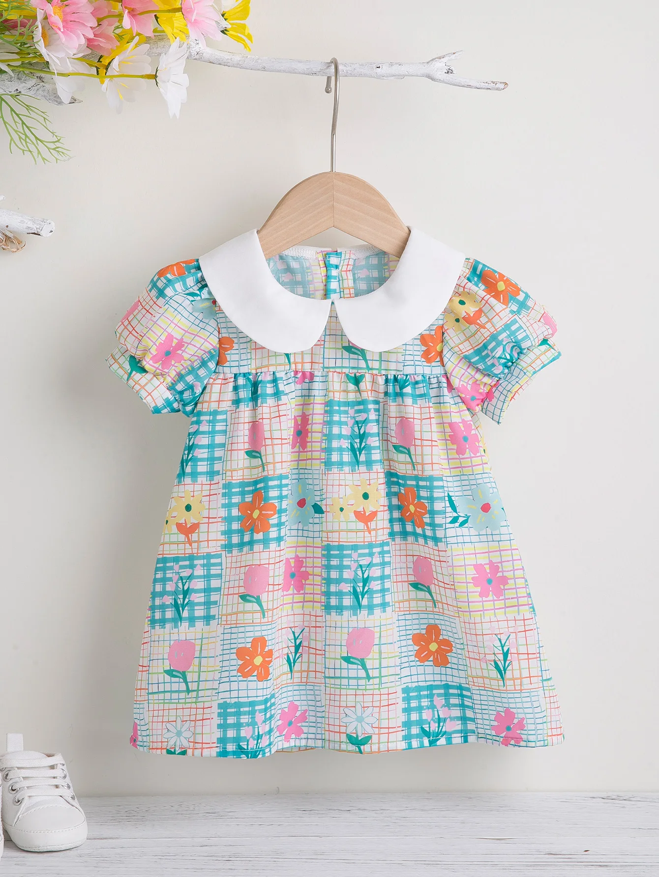A new dress for young girls for the spring and summer seasons with floral print, princess collar, and puffy sleeves, a cute and re...