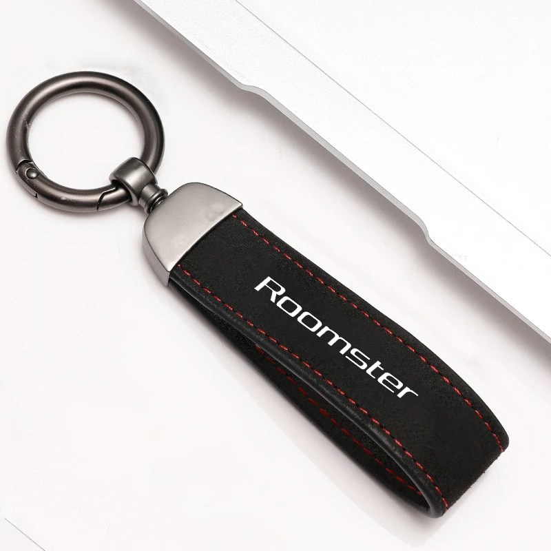 Elegant Metal and Suede Car Keychain with Emblem Design