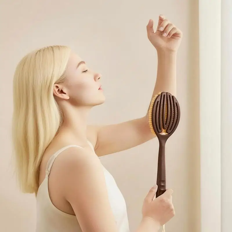 Soft natural bristle bath brush for dry skin care on a clean white background.