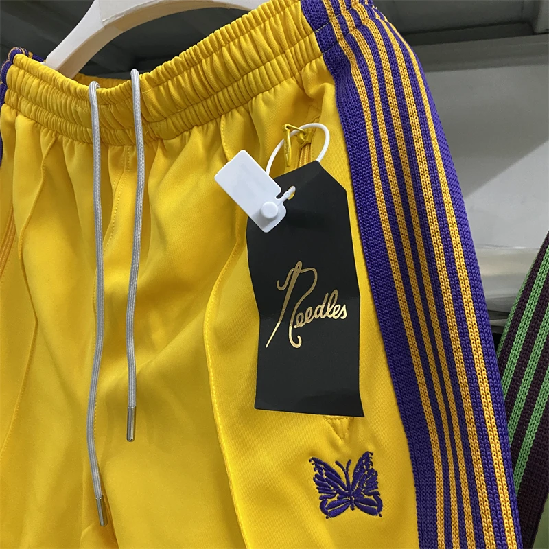 

New Fasion Yellow Needles Track Pants Men Women Poly Smooth sweatpants Butterfly Logo Knitted Purple Stripe Trousers Bermudas