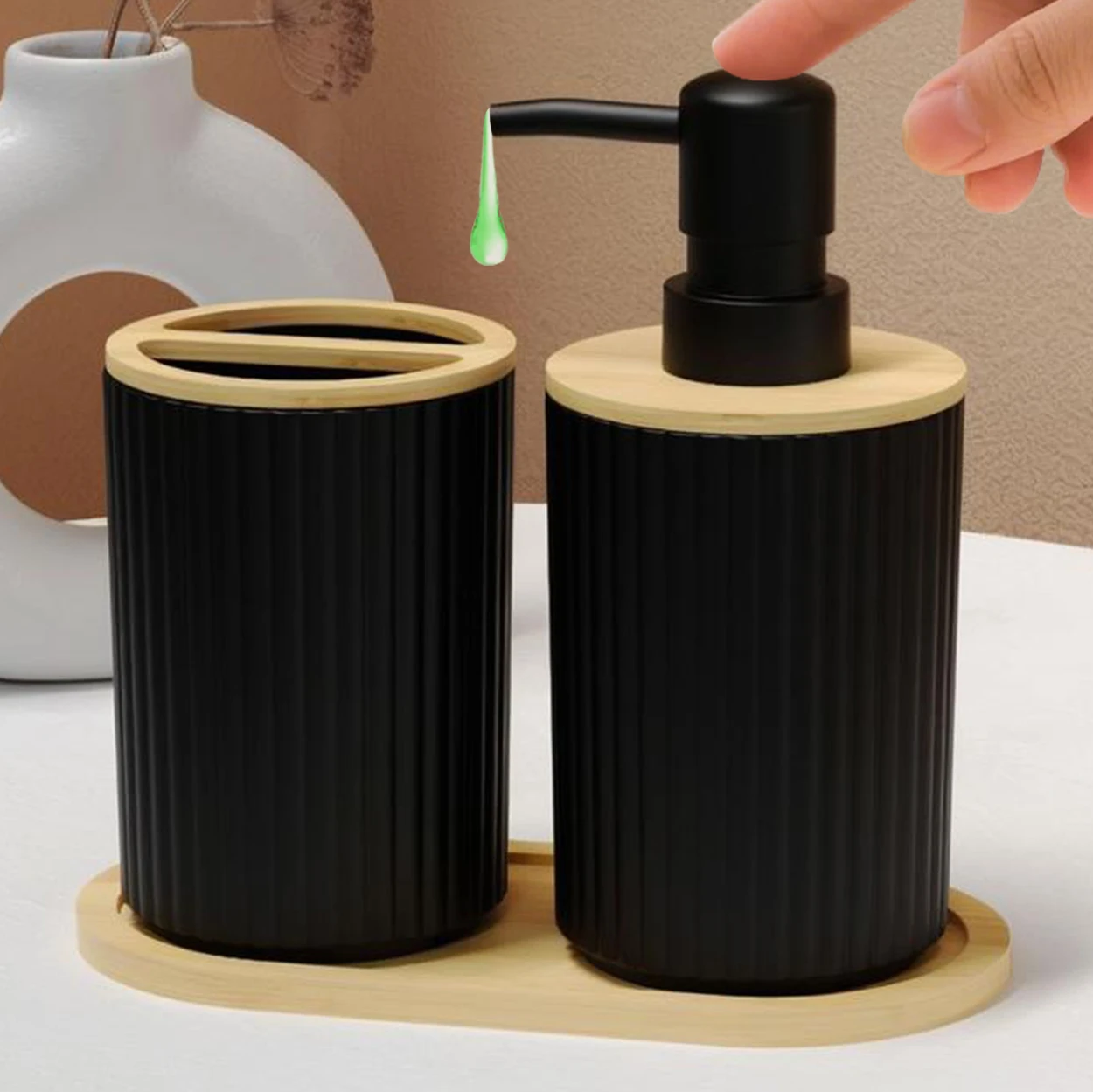 Side view of the black soap dispenser and toothbrush cup