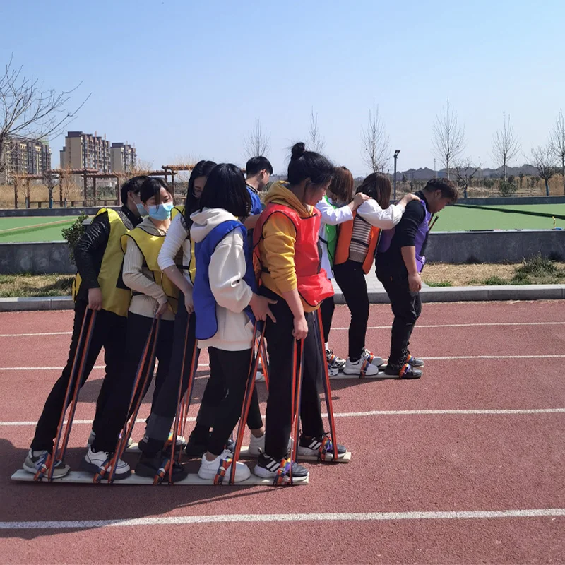 Fun sports event props working together in the same boat working together wooden board shoes racing walking game